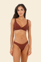 Knotted top that provides support and coverage in dark red