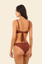 Knotted top that provides support and coverage in dark red