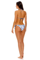 Ruched back bottom with ruffled edges and beaded tie sides in blue floral print