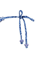Ruched back bottom with ruffled edges and beaded tie sides in blue floral print