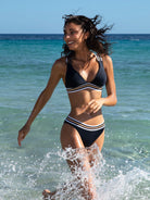 Low waist bottom in navy blue with gold and white stripes on the waist band