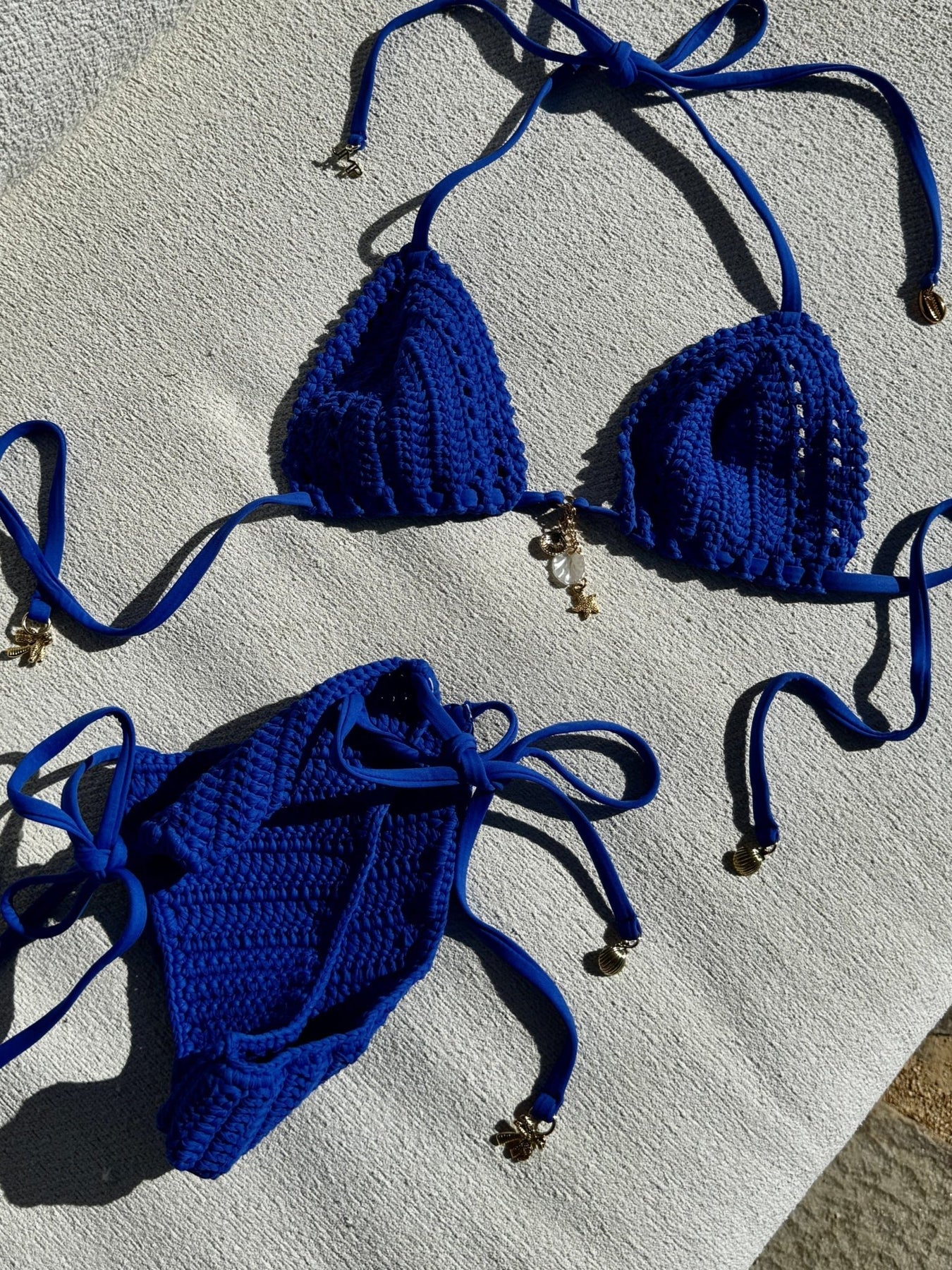 Adjustable triangle top with gold shell hardware in cobalt crochet