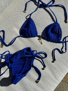 Adjustable triangle top with gold shell hardware in cobalt crochet