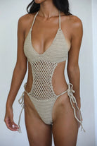 Crochet one piece with hand beaded pearls, side cutouts, tie sides and a halter tie behind the neck