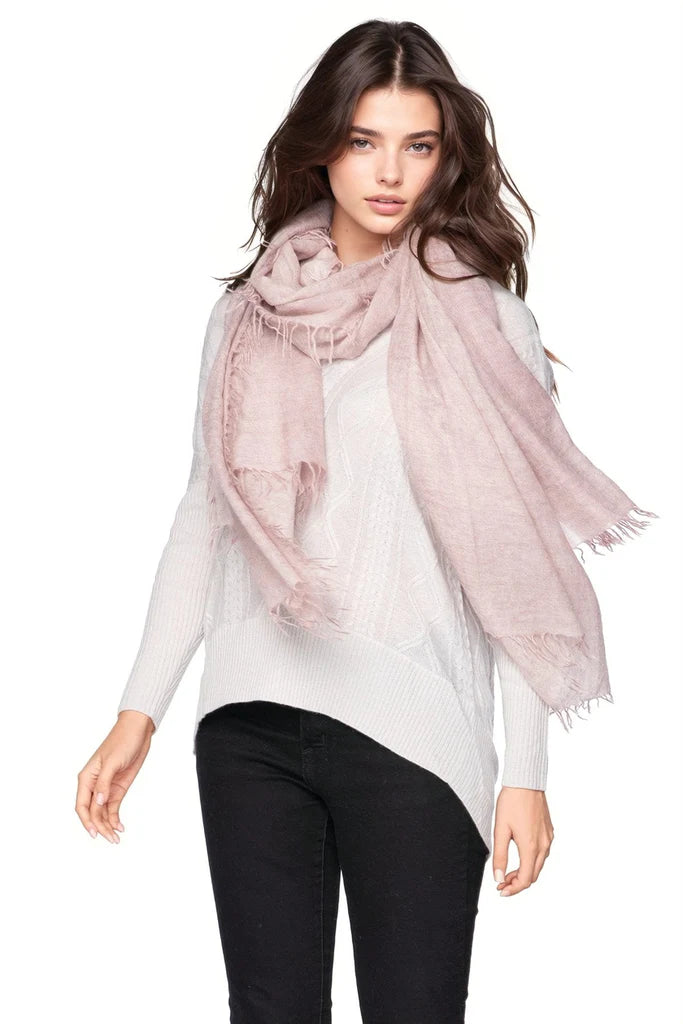 Woman wearing a light pink scarf on a white background