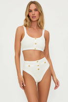 Textured ivory bottom with decorative gold buttons and a high waist fit.