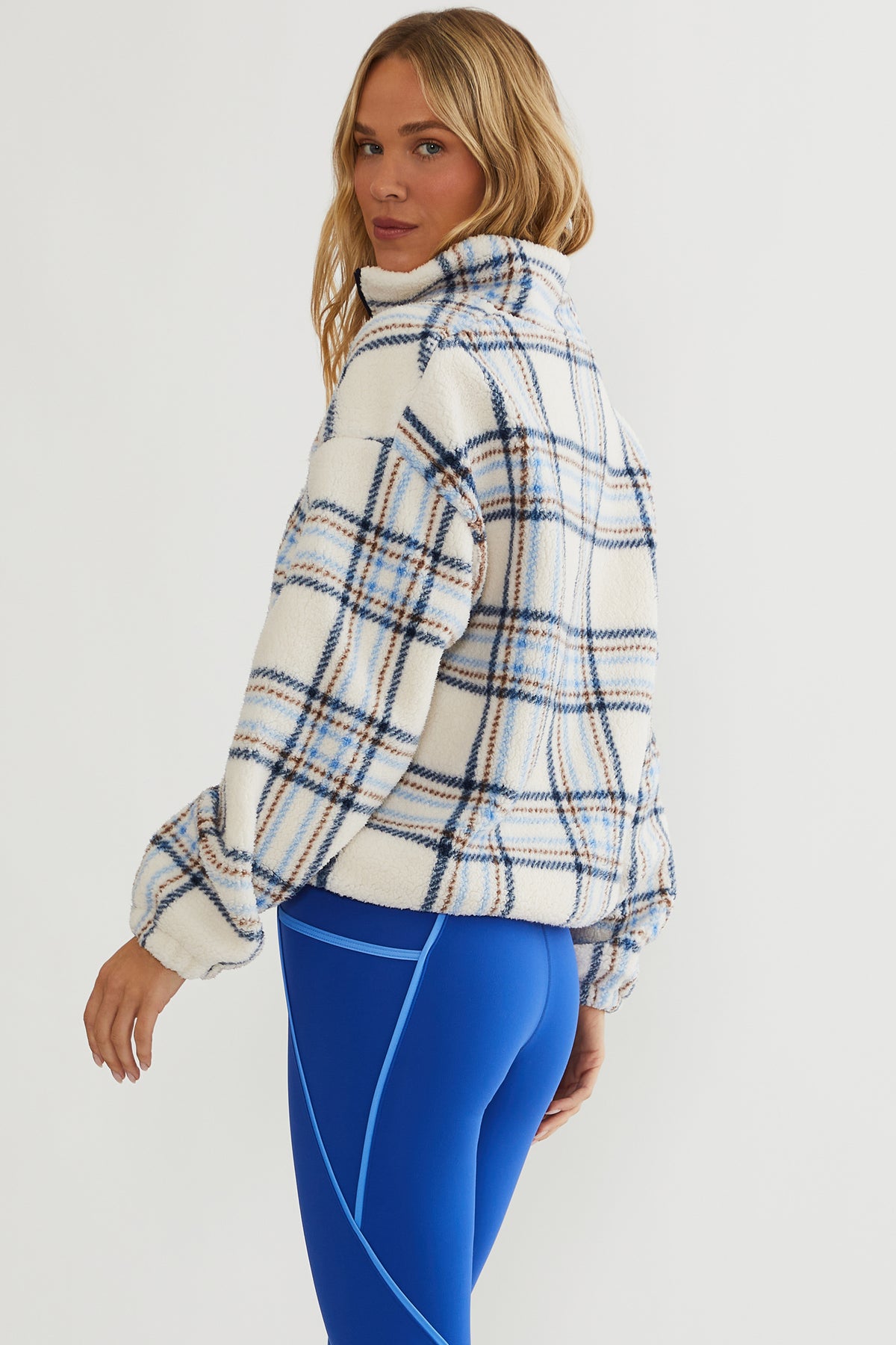 Faux fur pullover sherpa with a quarter zip neckline in plaid
