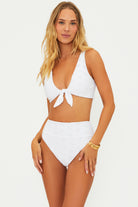 High waist bottoms with embroidered eyelet design in white