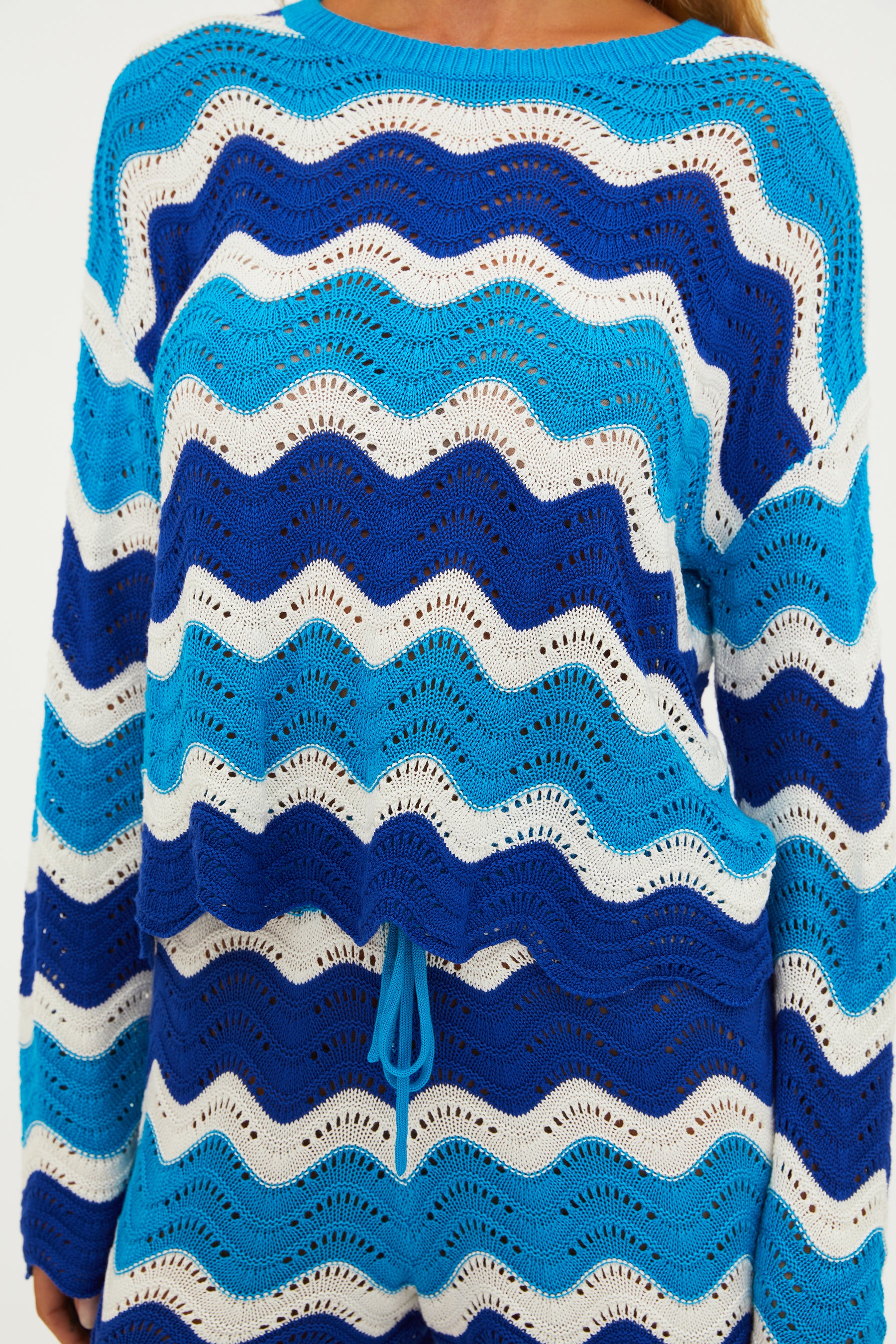 Open knit shorts with drawstring and elastic waistband in blue and turquoise wavy stripes