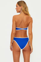 One piece with removable straps and side cutouts in blue with white blocking