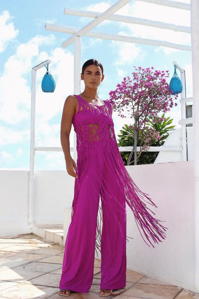 model wearing magenta pink pants with matching tube top and macrame coverup dress